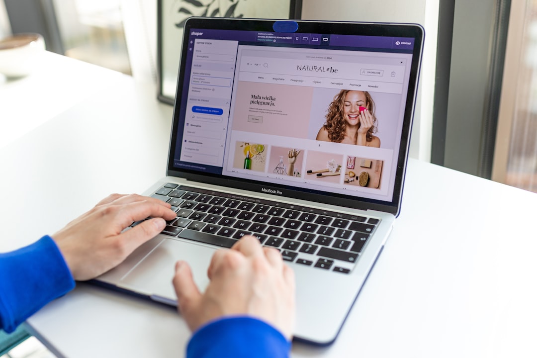 a person using a laptop computer on a table automated marketing personalization email campaigns