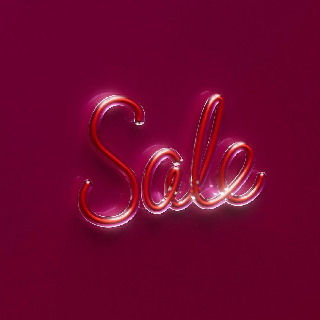 a pink background with the word sale written in neon lights seo success website traffic increasing sales