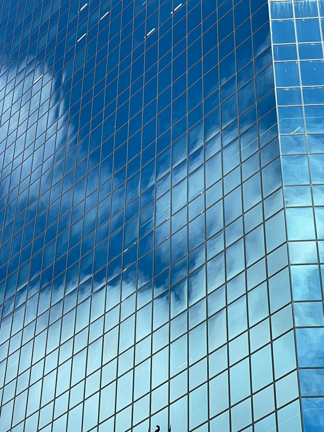 a very tall glass building with a clock on its side cloud security ccsp certification data protection
