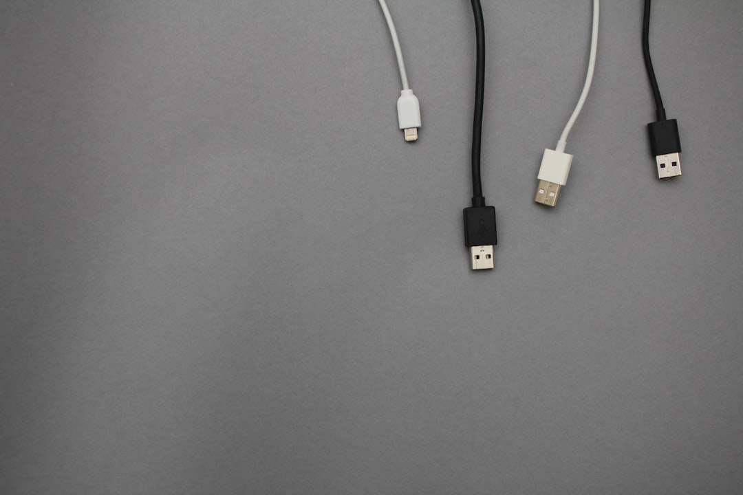 black and white usb data cables iphone connected laptop charging cable