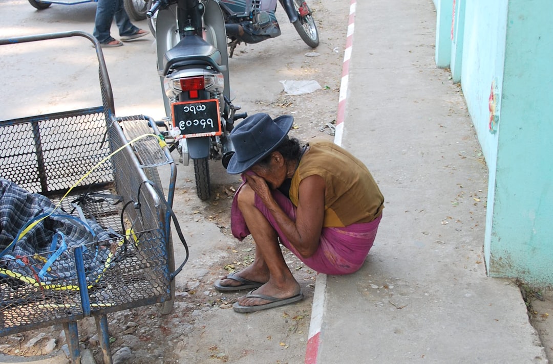 man in brown shirt sitting on gray pavement remote workers devices vpn internet