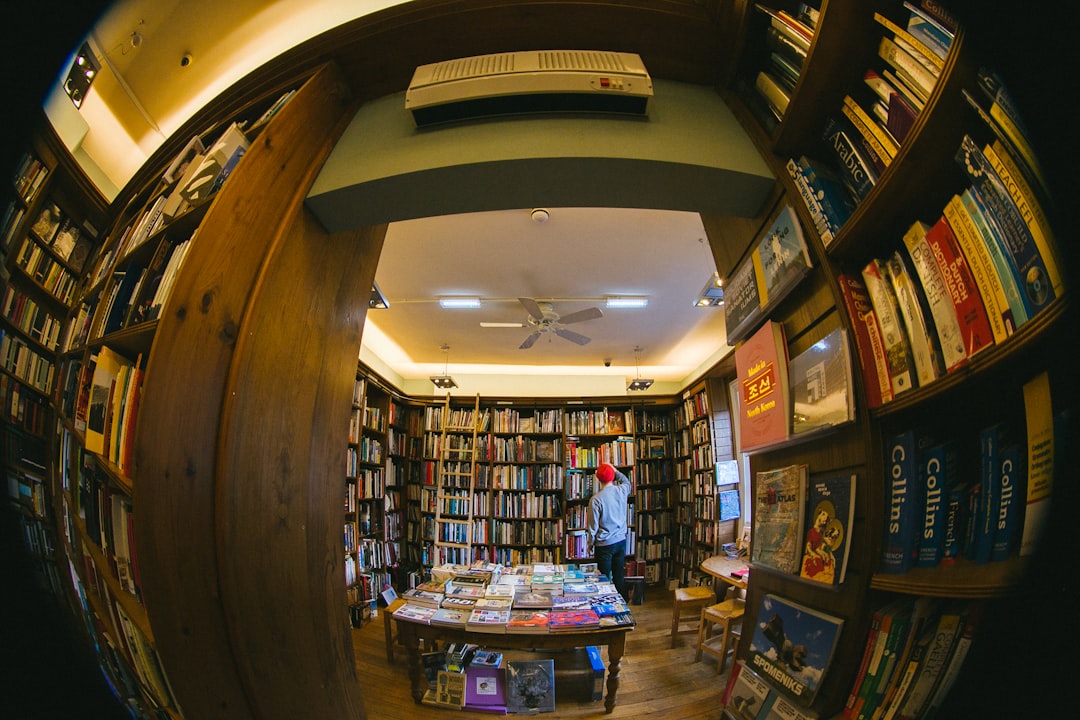 Success Stories: Online Stores Thriving with HostMonster eCommerce Hosting 1 person inside library online bookstore rare books ecommerce reading