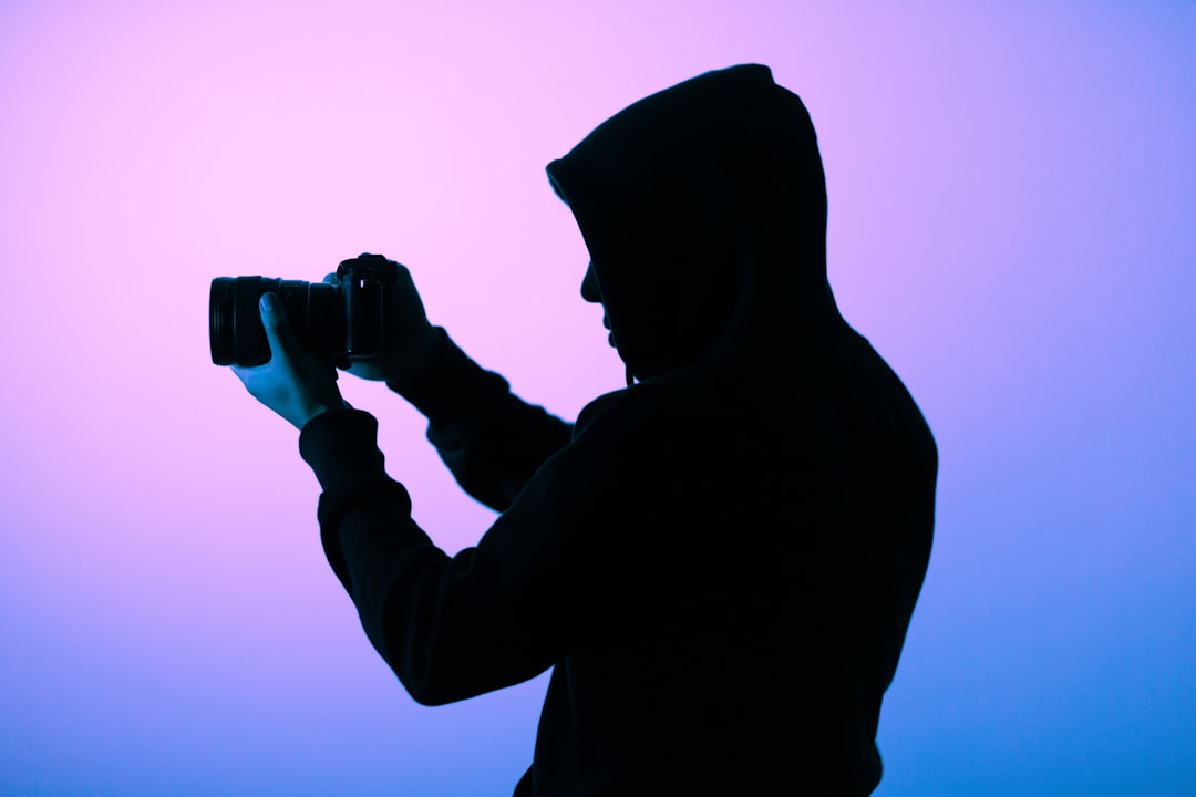 silhouette of person holding camera image upload cloud storage data privacy risk