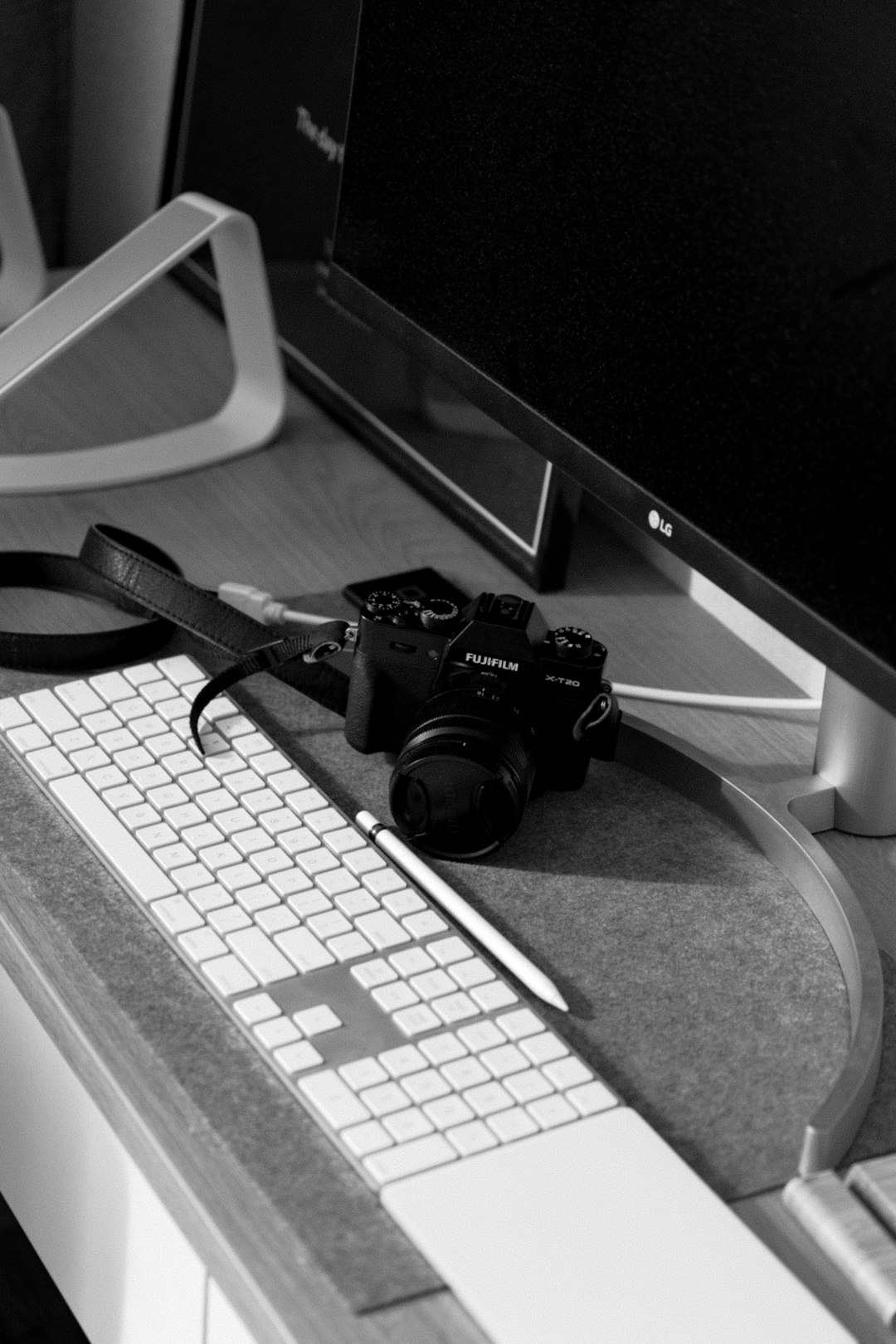 a black and white photo of a computer and a camera photographer at computer editing photos online tools