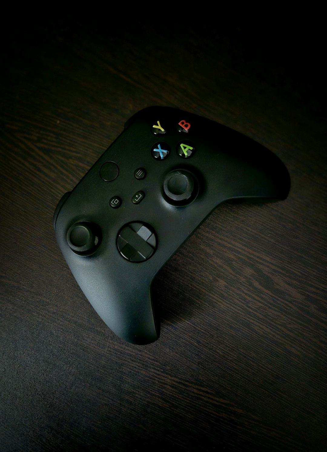 a close up of a remote control on a table xbox controller check bluetooth compatibility gaming setup