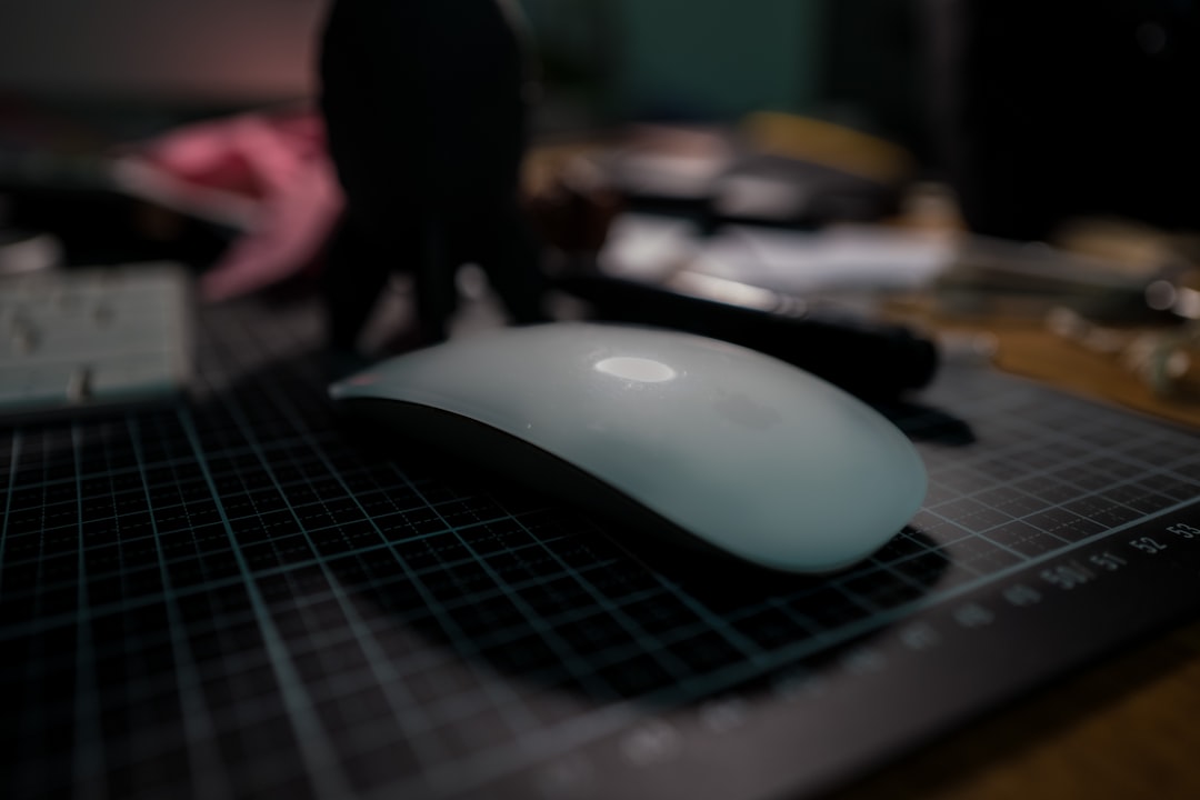 a computer mouse sitting on top of a table magic mouse gesture settings mac mouse settings