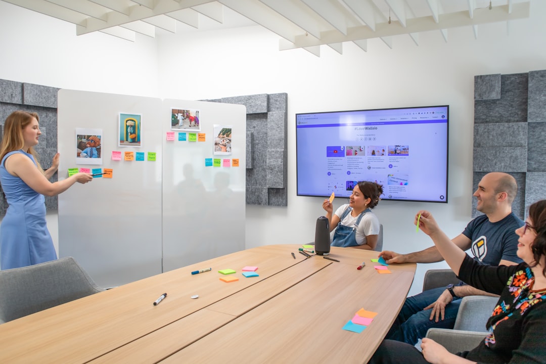 Top Remote Tools for Mac to Boost Your Work-from-Home Productivity in 2025 2 a group of people sitting around a conference table miro board virtual whiteboard team collaboration