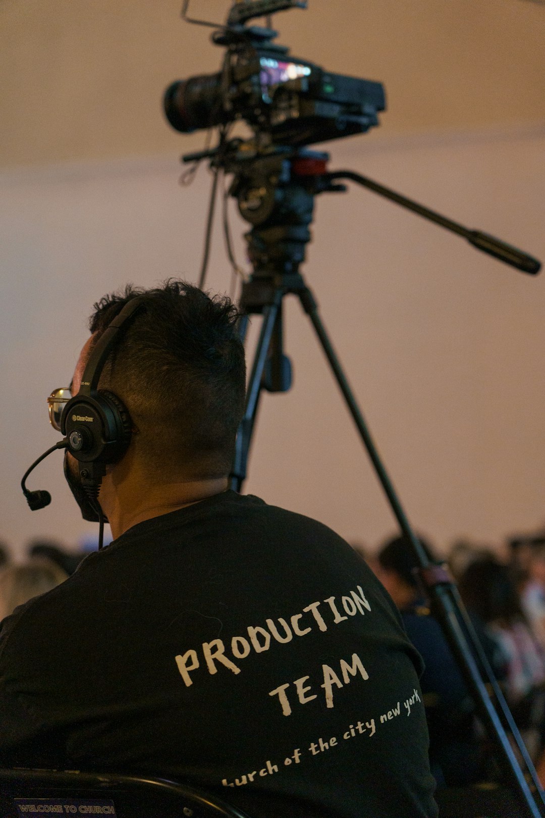 Choosing Between Photo and Ad Shoots: Objectives and Audience 2 a man sitting in a chair in front of a camera film crew advertising setup video shooting