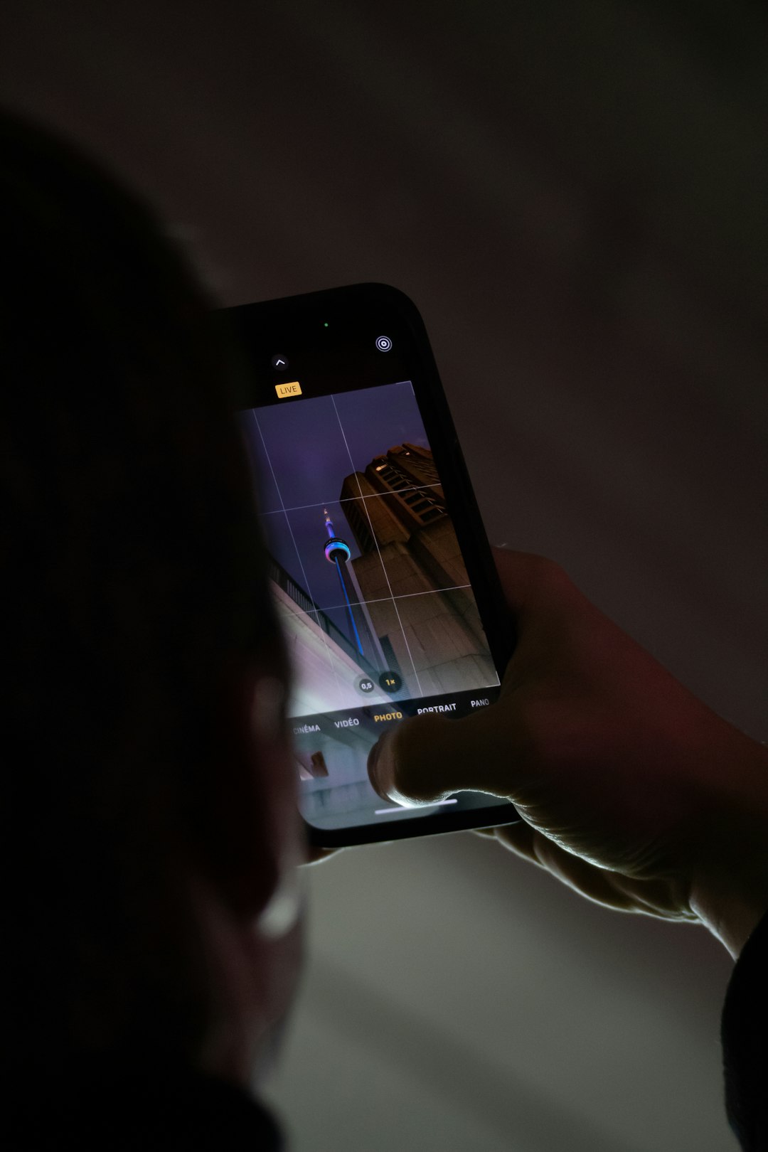 a person taking a picture with a cell phone person using smartphone settings privacy options screen headphones nearby