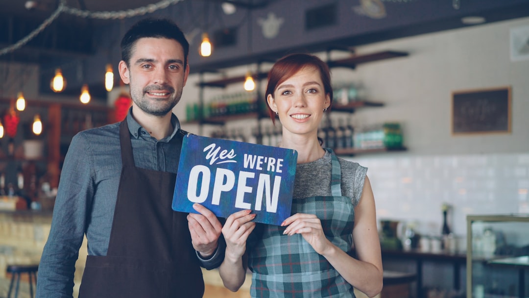 RingCentral and WordPress: Enhancing Customer Support with Powerful Integration 2 a smiling couple holds an open sign small business office customer service website integration 1