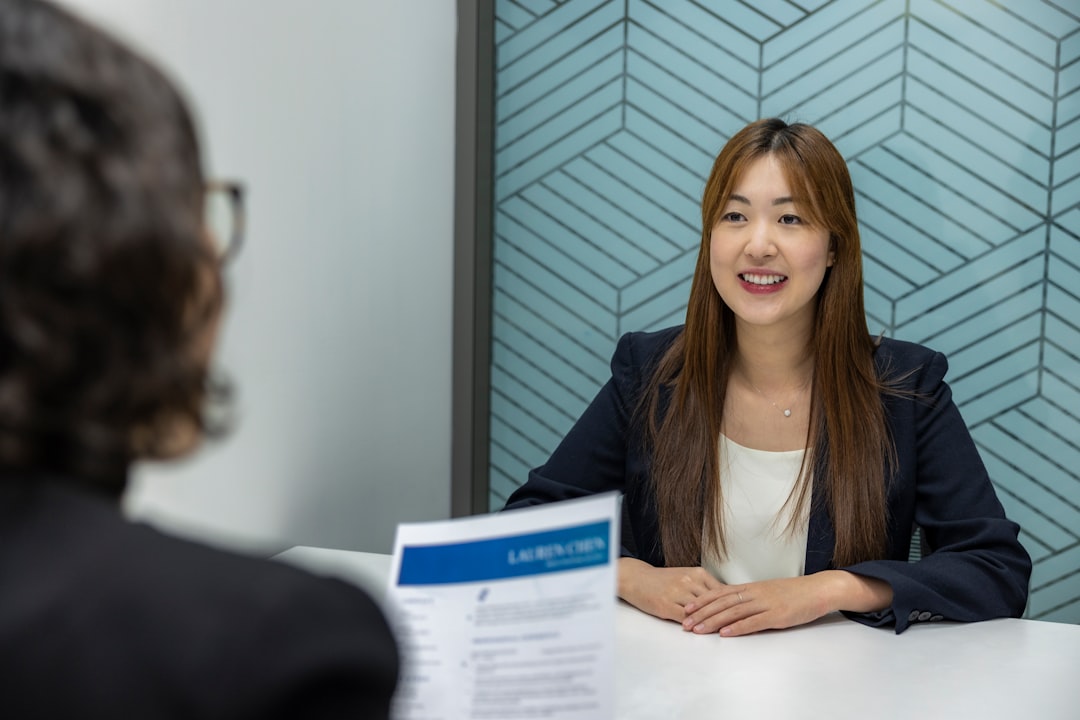 a woman sitting at a table with a piece of paper in front of her business meeting business comeback document approval