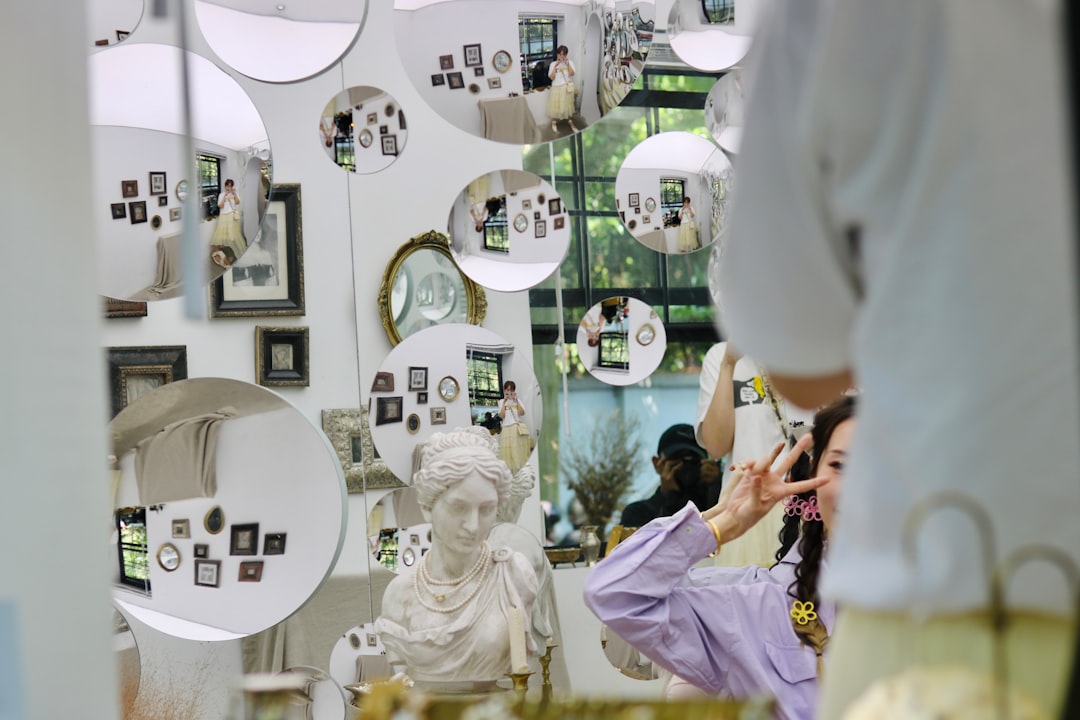 a woman standing in front of a mirror in a room sephora inside kohls makeup display beauty section