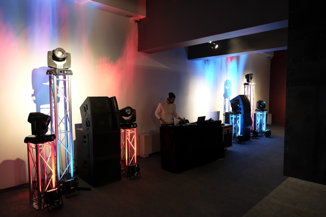 woman in white shirt standing on stage dj event big speaker concert sound