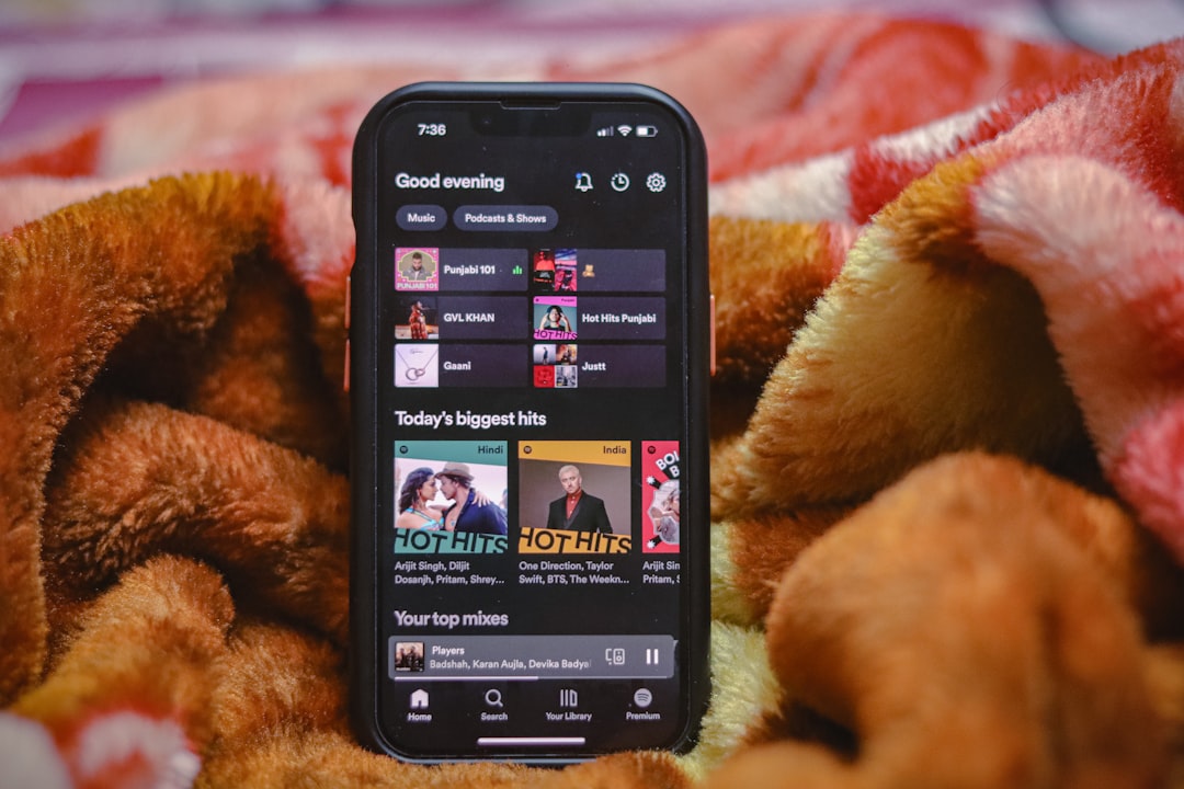 a close up of a cell phone on a blanket youtube music mobile app autoplay toggle autoplay icon