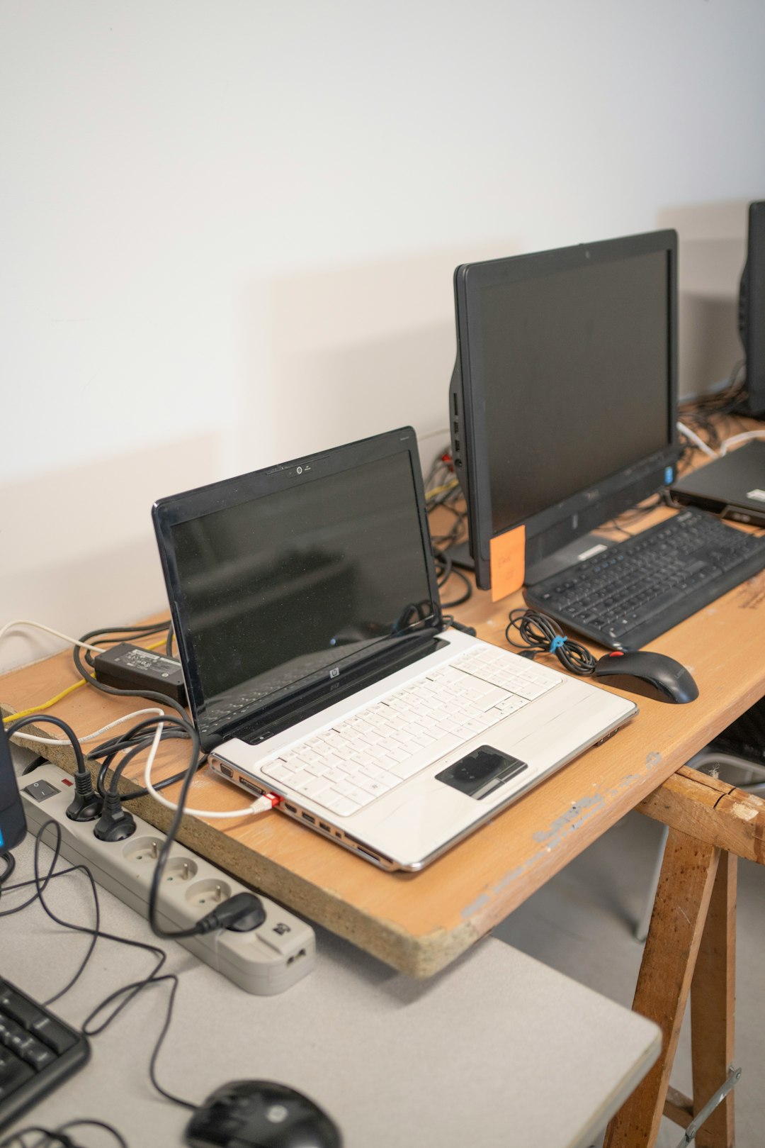 a desk with two laptops and a keyboard on it wifi router wireless signal internet connection