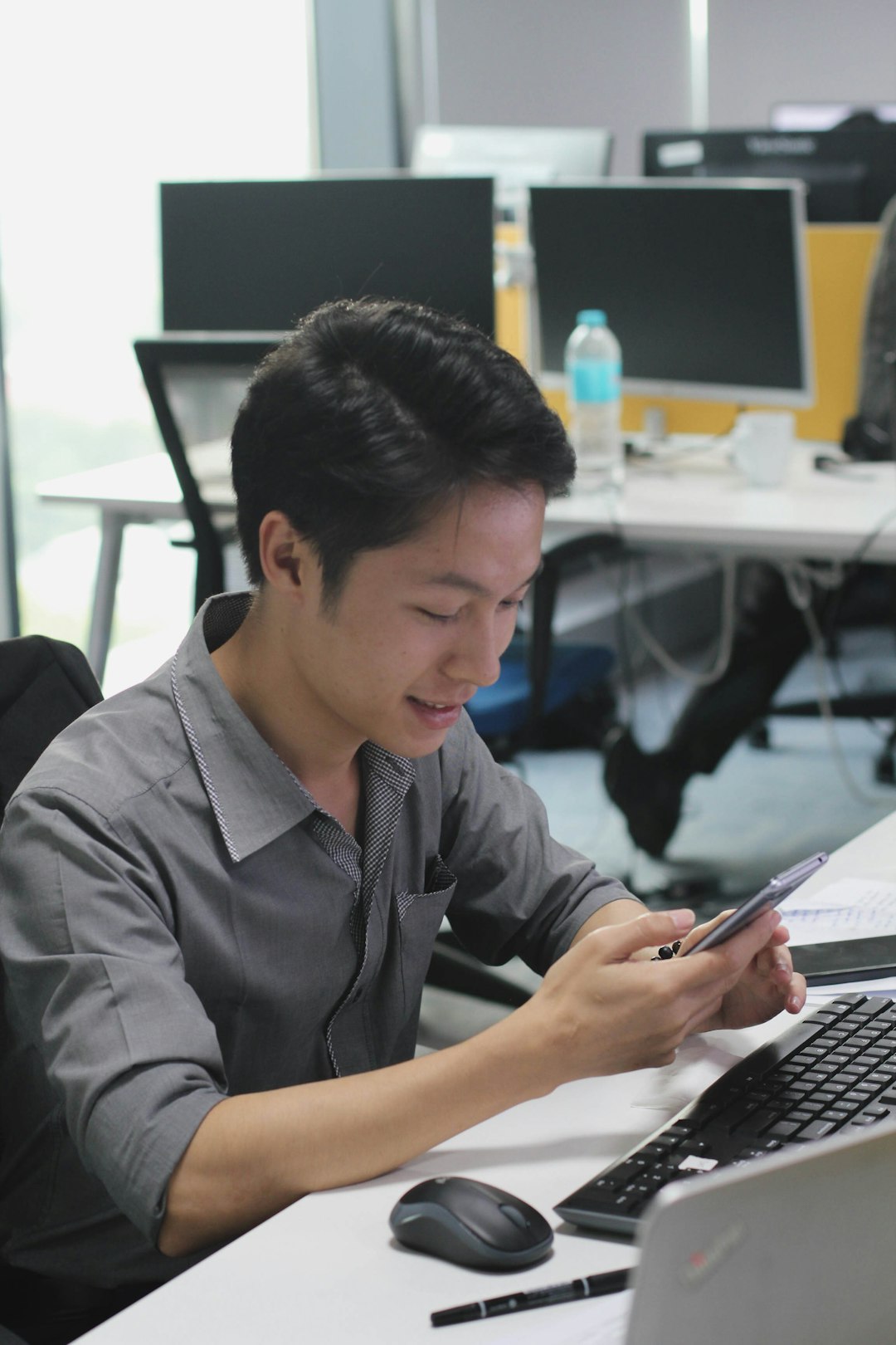 a man sitting at a desk using a cell phone blog post update seo analytics content refresh