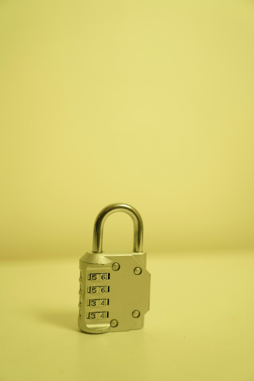 a padlock on a table with a yellow background emergency access smart lock failure backup key