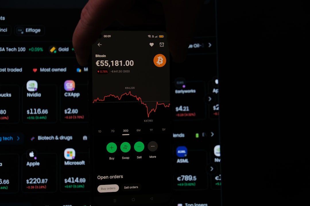 a person holding a cell phone in their hand crypto investment people using phones financial apps