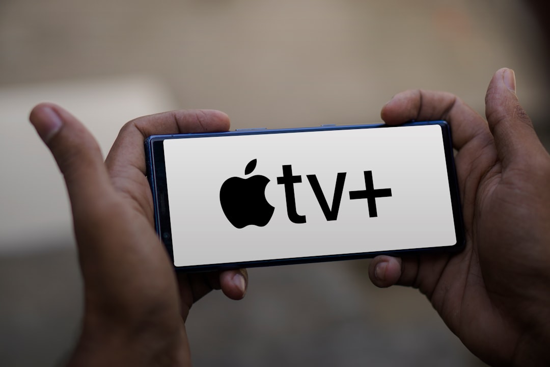 a person holding a smart phone with the apple tv plus logo on it apple tv chromecast roku amazon fire tv privacy comparison