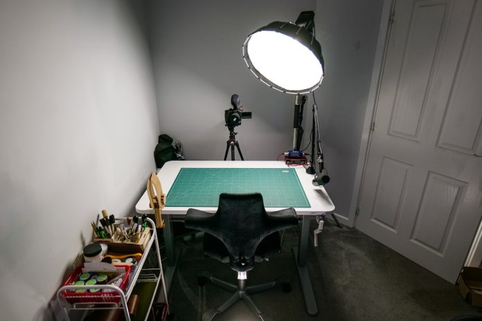 a room with a table and a light in it ring light, video lighting, studio setup