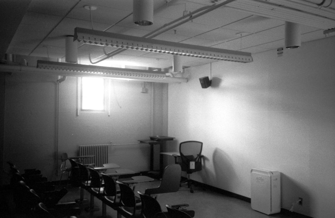 an empty classroom is lit with overhead lights business presentation projector classroom projector setup ceiling mounted projector