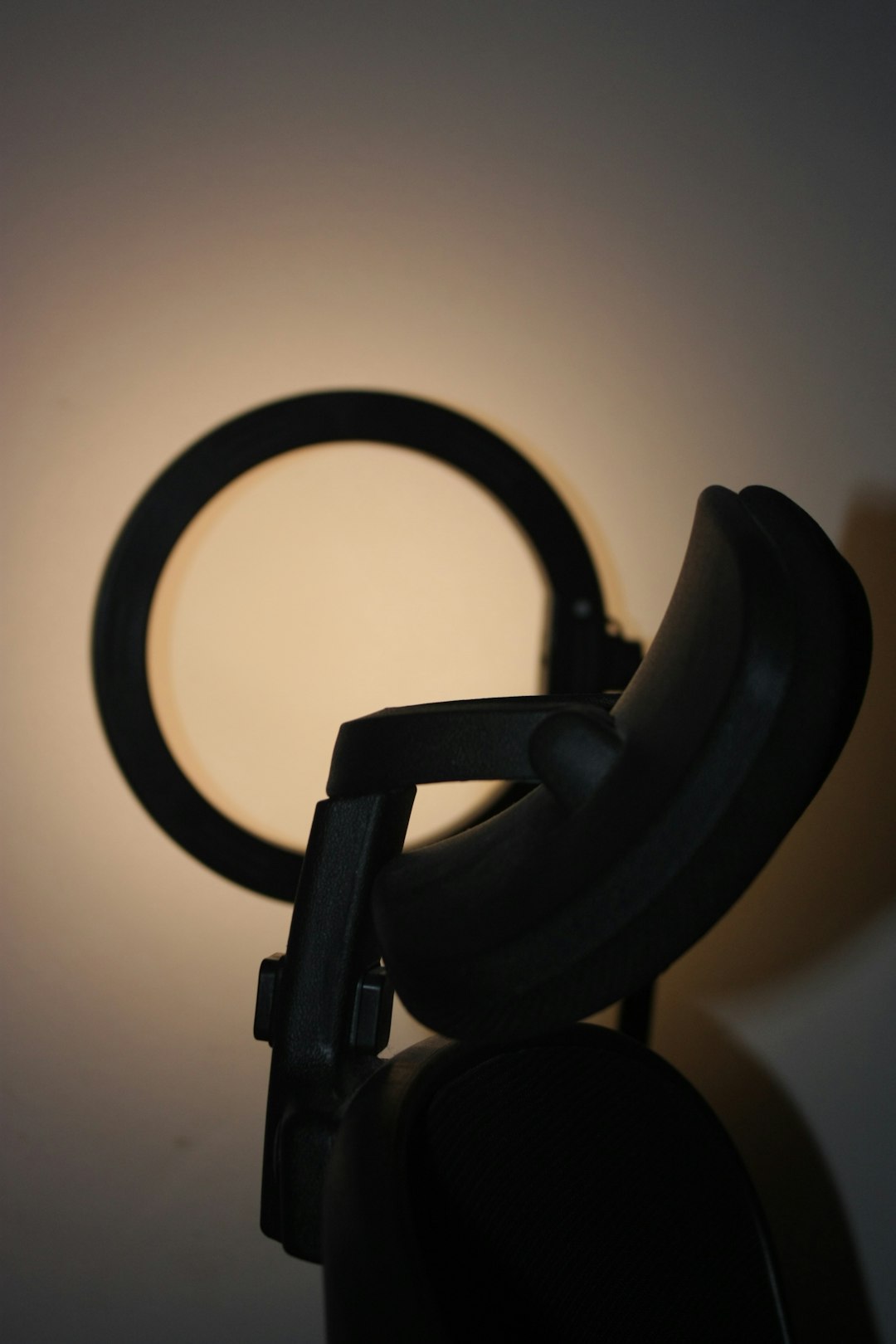 black chair with circular light behind it ring light video lighting studio setup