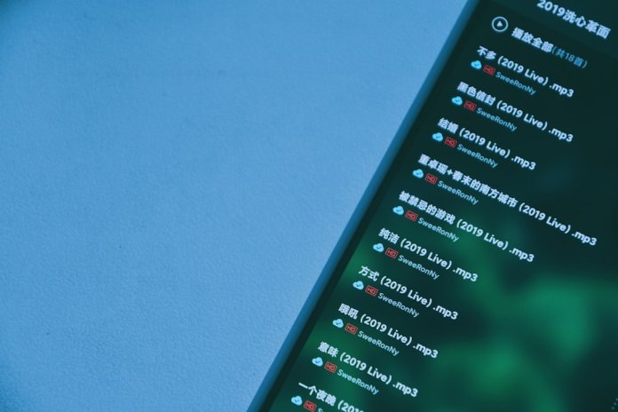 black smartphone on blue surface discord spotify settings, app cache, troubleshooting