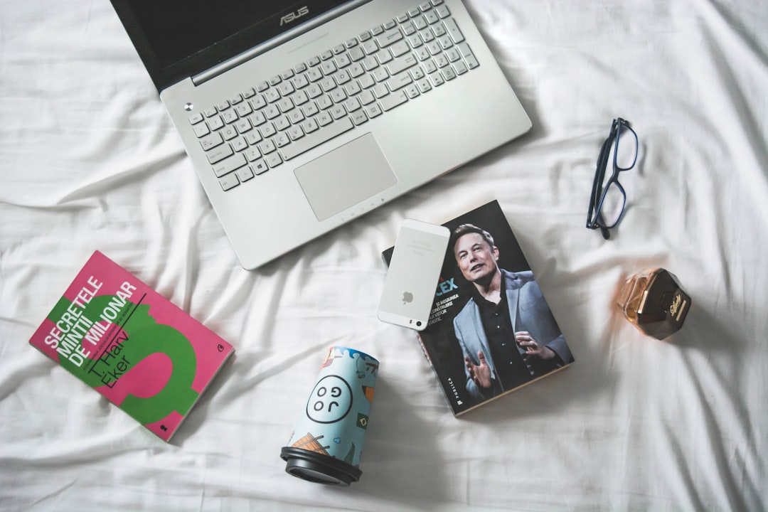 flat lay photography of macbook and book with eyeglasses lifestyle blogger social media strategy content planning 1