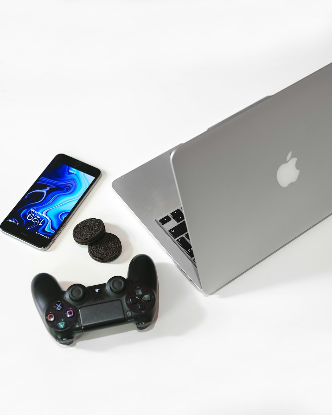 A17 Pro vs M2 performance explained 3 silver macbook beside black sony game pad mobile gaming m2 macbook game iphone gaming