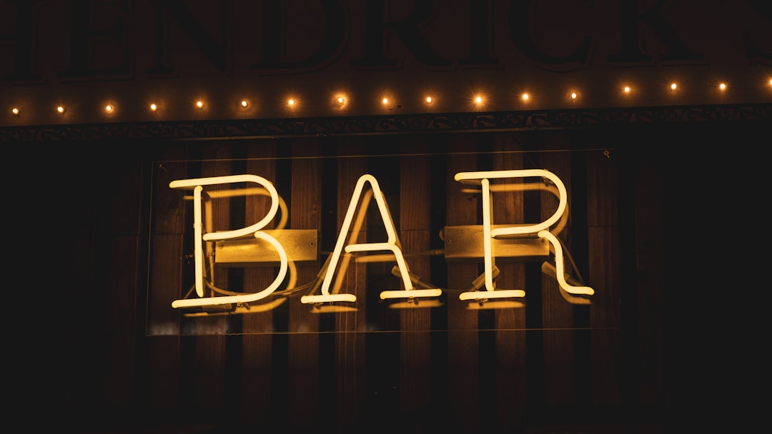 a bar sign lit up in the dark skull cocktail bar logo moody edgy dark bar