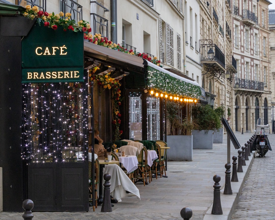 a cafe with lights on the outside of it paris travel charging devices coffee laptop