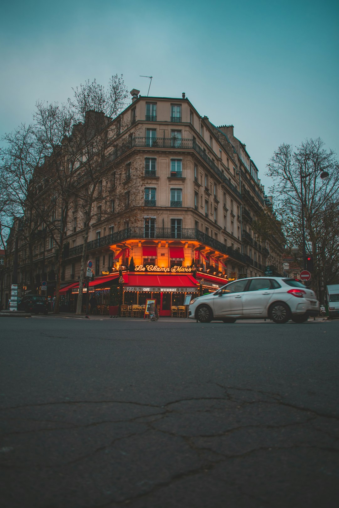 a car parked in front of a tall building paris travel charging devices coffee laptop