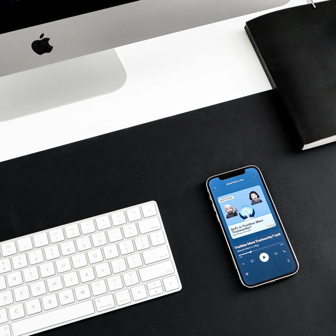 a cell phone sitting on top of a desk next to a keyboard ios automation iphone usage mobile workflow