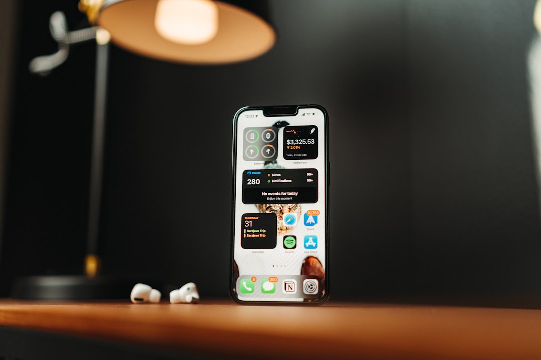 a cell phone sitting on top of a wooden table ios automation iphone usage mobile workflow