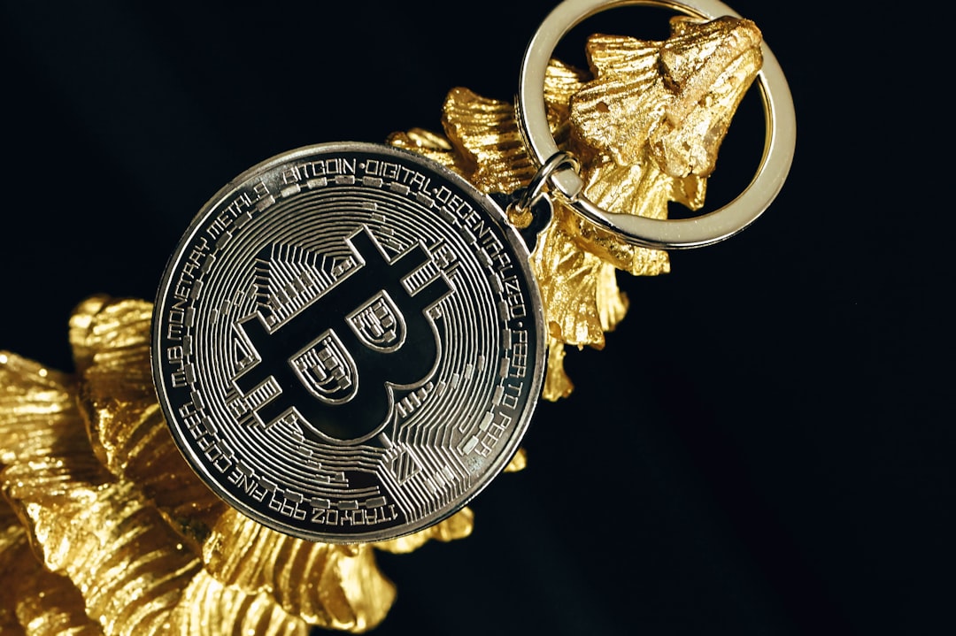 a golden keychain with a bitcoin on it crypto business licensed fintech company digital currency regulation