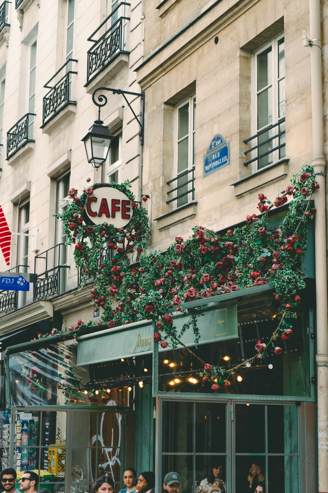 a group of people standing outside of a cafe paris travel charging devices coffee laptop