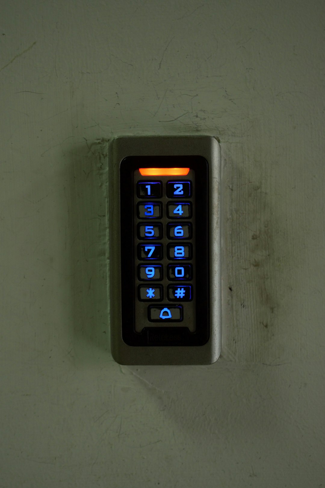 a key board mounted to a wall in a room smart home door lock user access control mobile app lock 1