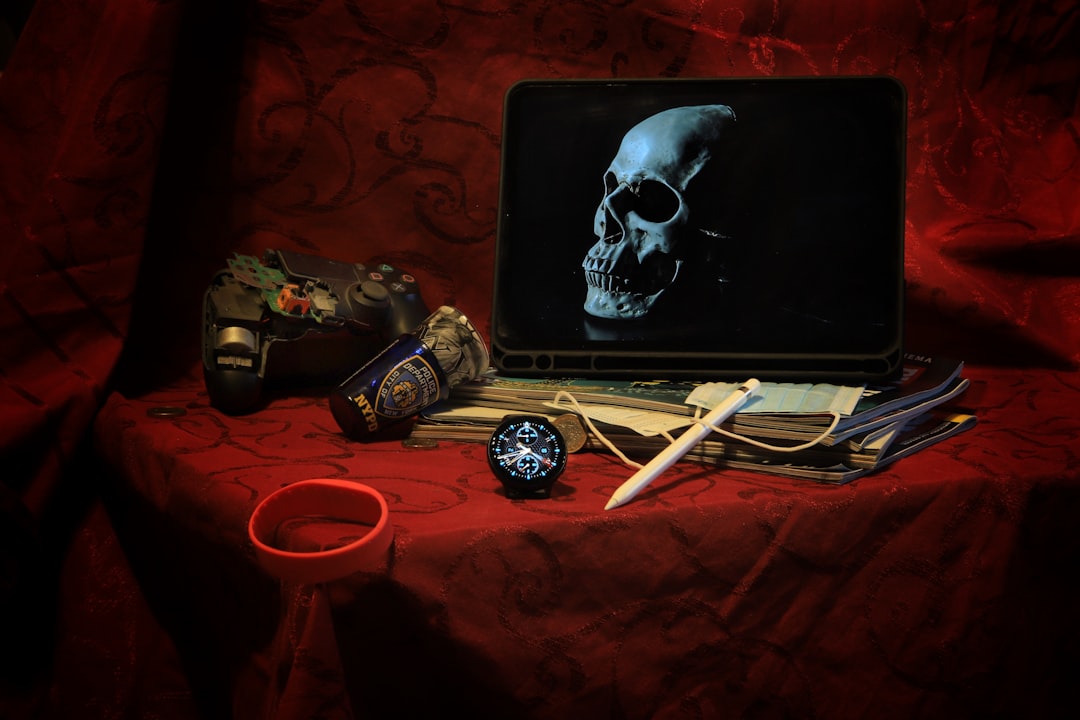 a laptop computer sitting on top of a red table indie horror set scriptwriter director with laptop