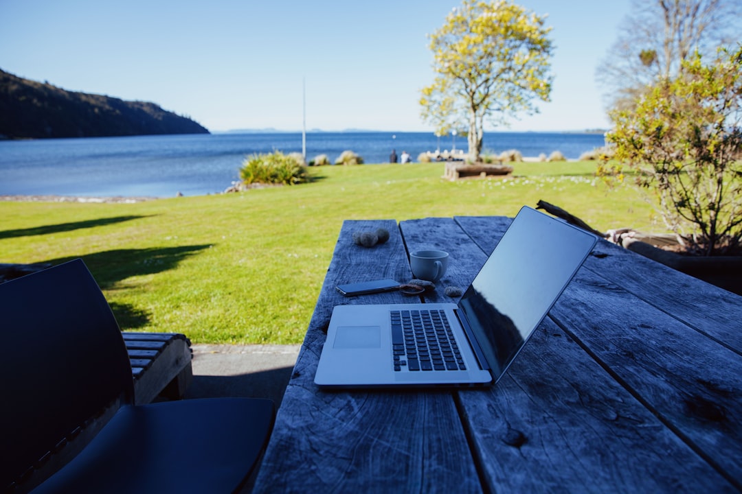 a laptop computer sitting on top of a wooden table wordpress plugin dashboard vacation rental booking calendar integration