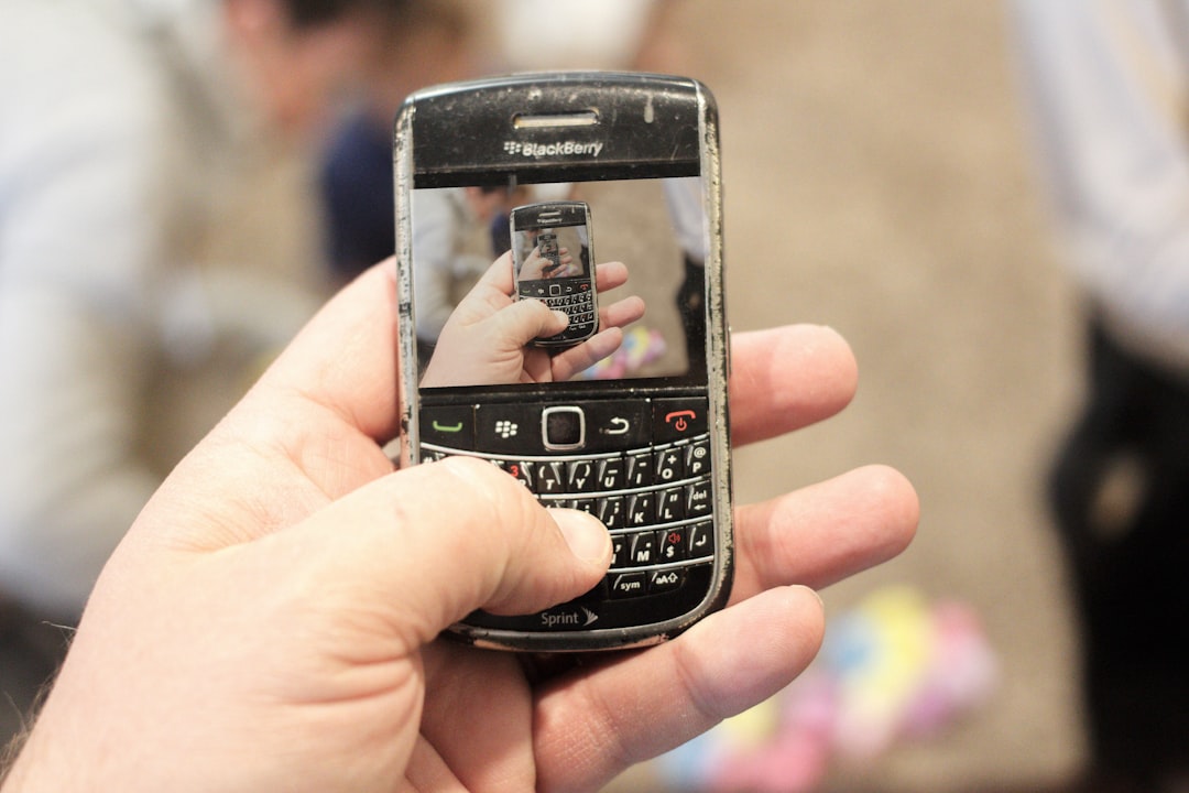 a person holding a cell phone in their hand low budget smartphone outdated phone features entry level user 1