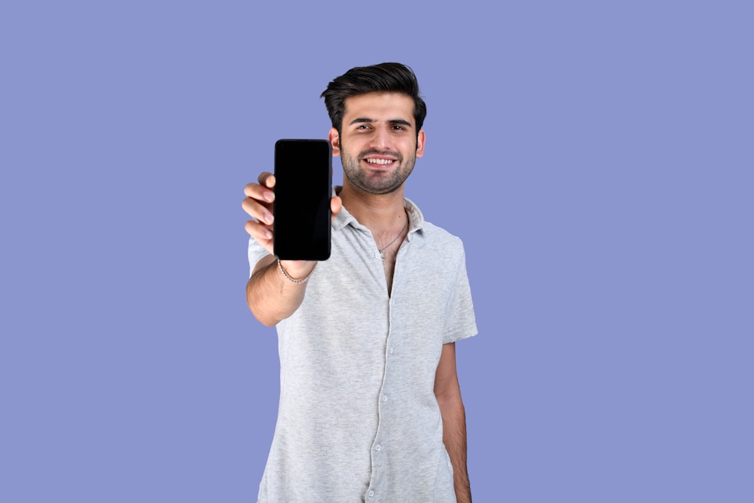 a person holding a phone low budget smartphone outdated phone features entry level user