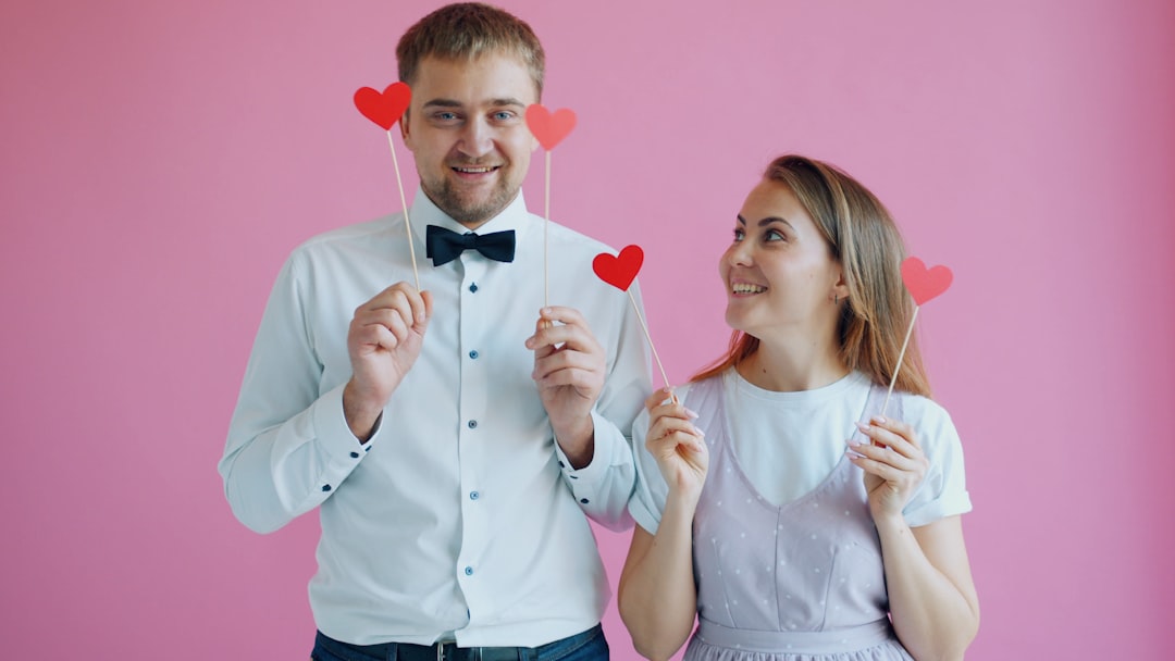couple holding red hearts on sticks lgbtq party hookup dating app