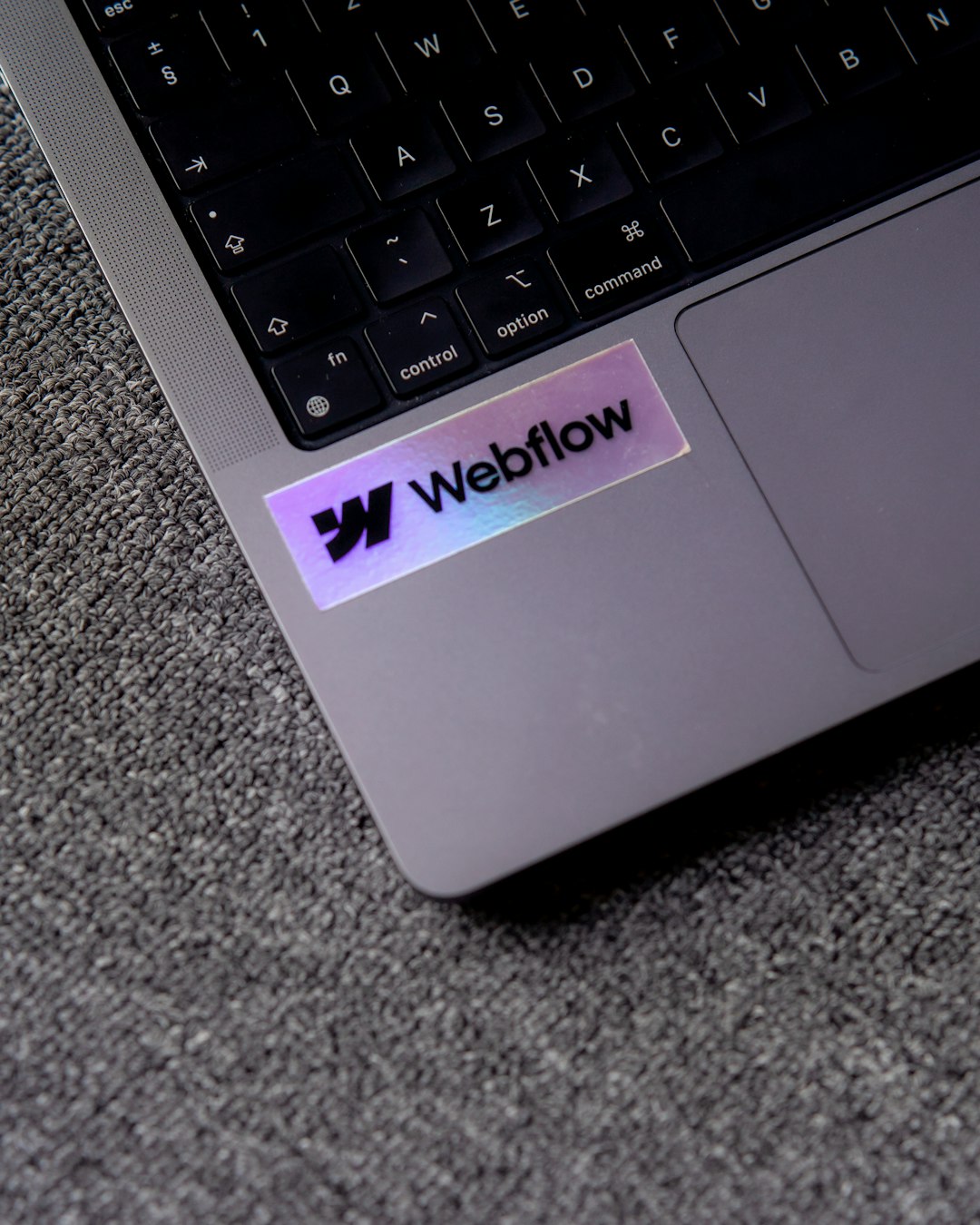 a close up of a laptop with a sticker on it webflow interface design cms