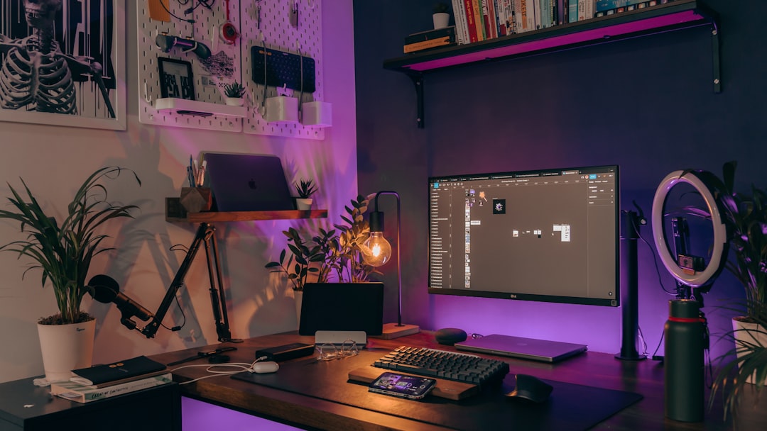 a desk with a monitor keyboard and mouse indie game development small studio creative workspace