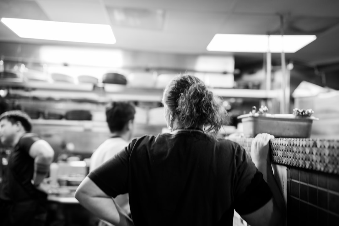 a group of people in a kitchen preparing food restaurant team kitchen scheduling employee coordination