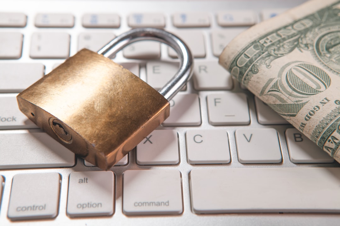 a padlock and dollar bills rest on a computer keyboard facebook messages online security buyer protection