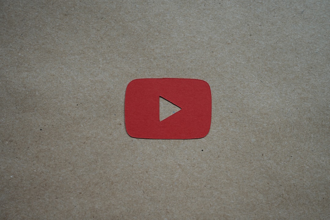 a red play button sitting on top of a piece of paper youtube thumbnails video optimization title design