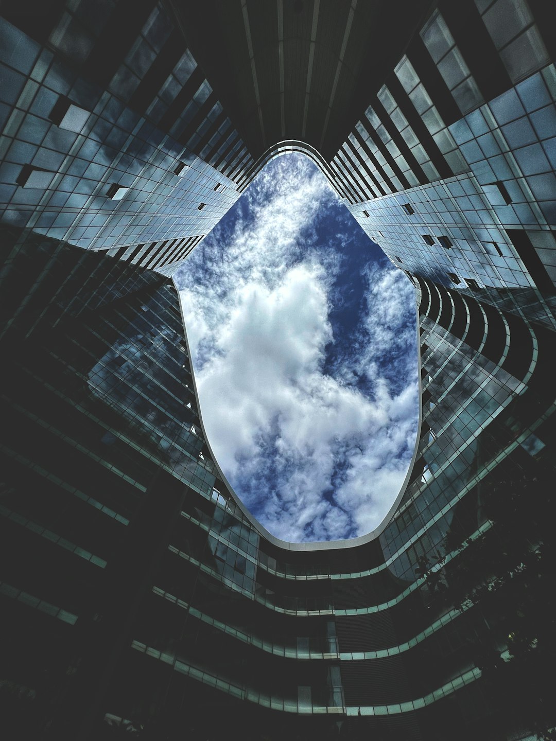 a very tall building with some clouds in the sky cloud integration digital communication future technology
