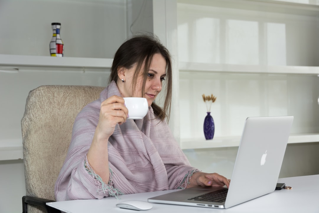 a woman sitting at a desk with a laptop and a cup of coffee angry customers online reviews complaint forum