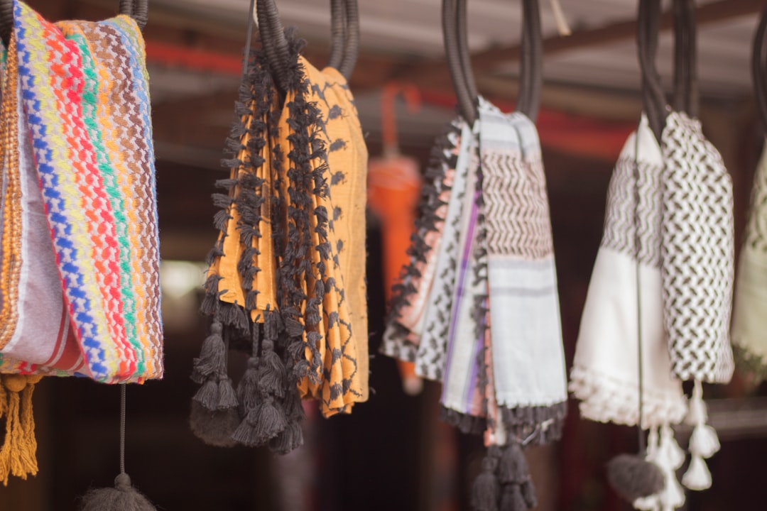 assorted color clothes hanged on black metal rack handmade fashion ecommerce success knit products